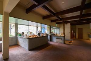 a restaurant with a counter in a room with windows at 入山登 in Hakuba