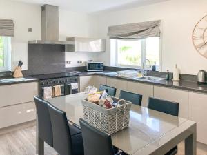 a kitchen with a table with a basket of food on it at Dalvista Cottage in Leurbost +33 photos