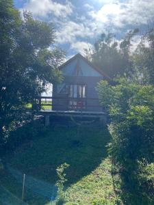 a small house in the middle of a yard at Pousada Jardins da Gastehaus in Triunfo
