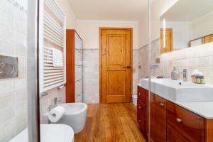a bathroom with a sink and a toilet and a mirror at Maison Carrel Elegant 4 in Breuil-Cervinia +39 photos