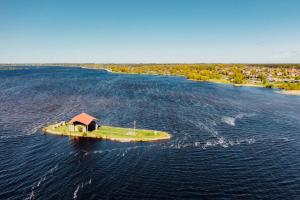 an island in the middle of a large body of water at Apartamenti Ikšķile in Ikšķile