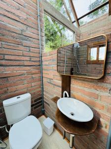 a bathroom with a toilet and a sink at Pousada Jardins da Gastehaus in Triunfo +50 photos