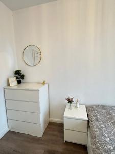 a bedroom with a bed and a mirror and a dresser at Apartment Brunsbüttel 3 in Brunsbüttel