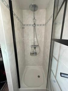 a shower with a glass door in a bathroom at L'Opaline-Maisonnette 28m2 grand confort avec jardin-tout inclus in Tully +19 photos