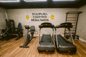 a gym with treadmills and weights in a room at Slim Hotel Cuiabá Aeroporto in Cuiabá