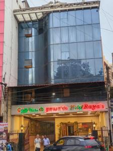 a building with a car parked in front of it at Hotel Raya's Annexe 1 in Kumbakonam