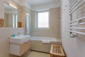 a bathroom with a sink and a tub and a window at Apartamenty Tulip - visitopl in Międzyzdroje +71 photos
