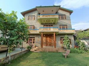 a house with a balcony on top of it at Inayat hotel in Srinagar
