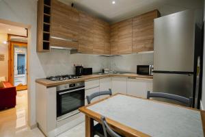 a kitchen with a table and a stainless steel refrigerator at 9 Studio Flat in Victoria