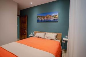 a bedroom with a bed and a painting on the wall at 9 Studio Flat in Victoria