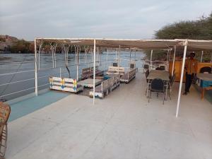 a boat with a canopy and tables and chairs at Nile Dream Yacht in Jazīrat Salūjah