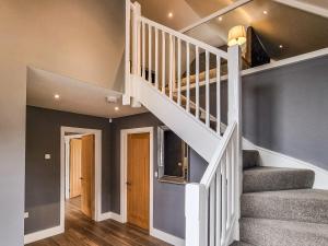 a white staircase in a home with blue walls at The Stables - Uk38514 in Babcary