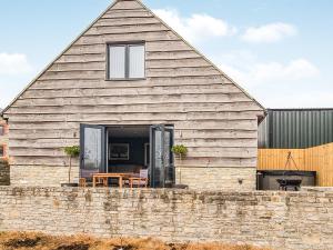 a barn with a table and chairs in front of it at The Stables - Uk38514 in Babcary