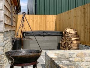 a grill sitting on a wall next to a building at The Stables - Uk38514 in Babcary