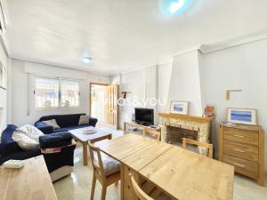 a living room with a couch and a table at Amapolas by Villas&You in Orihuela Costa