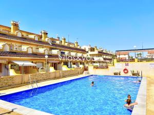 two people in the swimming pool at a hotel at Amapolas by Villas&You in Orihuela Costa