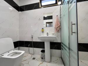 a bathroom with a toilet and a sink and a shower at Ganja VIP Home in Ganja