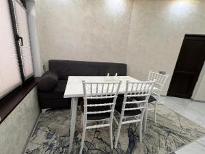 a white table and chairs in a room with a couch at Ganja VIP Home in Ganja +5 photos
