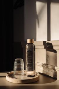 a bottle and a glass on a table at Adam Downtown in Amsterdam