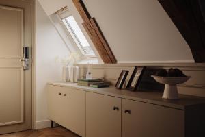 a room with a counter with a window and a sink at Adam Downtown in Amsterdam +29 photos