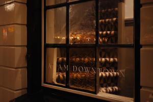 a window of a wine cellar with the words my driveway at Adam Downtown in Amsterdam