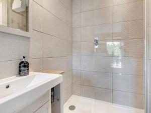 a bathroom with a white sink and a shower at 1 Bed in Broadway oc-broad in Broadway +16 photos