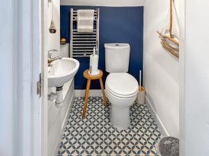 a bathroom with a toilet and a sink at Beach Haven in Sheringham