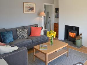 a living room with a couch and a coffee table at Beach Haven in Sheringham