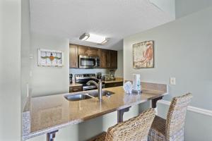 a kitchen with a sink and a counter top at Sugar Beach 313 in Gulf Shores +36 photos