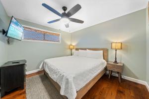 a bedroom with a bed and a ceiling fan at Sugar Beach 313 in Gulf Shores