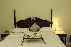 a bedroom with a large bed with a coffee table on it at Ratan Vilas in Jaipur