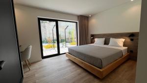 a bedroom with a bed and a large window at Chestnut hill - Geres in Ventosa
