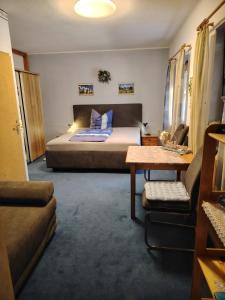 a bedroom with a bed and a couch and a table at Gästehaus Schirner in Niederau +28 photos