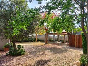 a courtyard with trees in front of a building at Suites on 74 in Worcester
