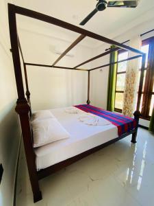 a bed in a room with a canopy bed at Liya Villa in Ahangama