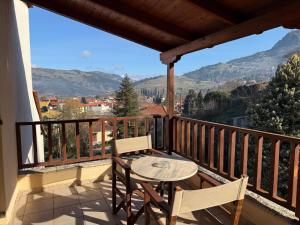 a table and chairs on a balcony with a view at Driades in Kalavrita