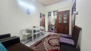 a living room with a table and a dining room at Crystal Mansion in Hyderabad