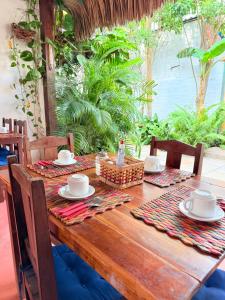 a wooden table with plates and dishes on it at Rede Andrade Calamarina in Jericoacoara