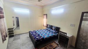 a small bedroom with a bed and a mirror at Crystal Mansion in Hyderabad