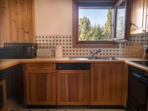 a kitchen with a sink and a window at Comfortable 2 bedroom apartment in Gryon in Gryon