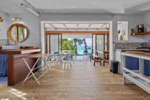 a kitchen and dining room with a view of the ocean at BlueMoon Studio on the Beach! in Trou d'Eau Douce +17 photos