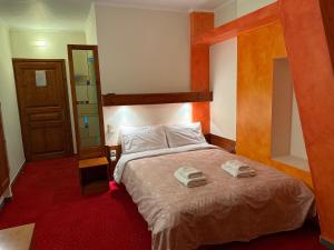 a bedroom with a bed with two towels on it at Driades in Kalavrita