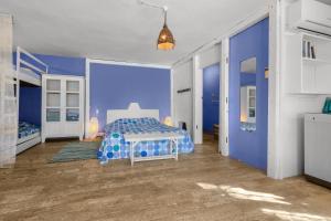 a blue bedroom with a bed and a blue wall at BlueMoon Studio on the Beach! in Trou d'Eau Douce