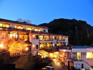 a large building with lights on at night at かね吉一燈庵 in Mitaka