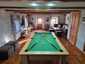 a living room with a pool table in it at Osada Jeździecka Bata in Mirsk +17 photos