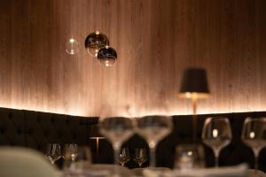 a row of wine glasses on a table in a restaurant at Hotel Cristina Wellness Relax in Pinzolo