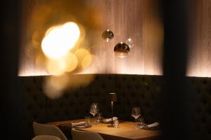 a dining room with a table and chairs and lights at Hotel Cristina Wellness Relax in Pinzolo