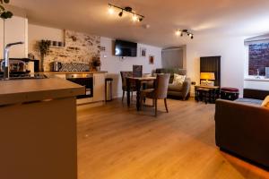 a kitchen and living room with a table and a couch at The Music Rooms in Bewdley +24 photos