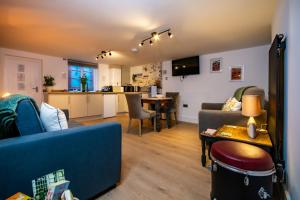 a living room with a couch and a table at The Music Rooms in Bewdley