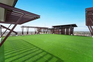 a view of a soccer field with a stadium at Ubec Vacation Home - Royal Oceancrest Mactan Cebu Condominium in Cebu City